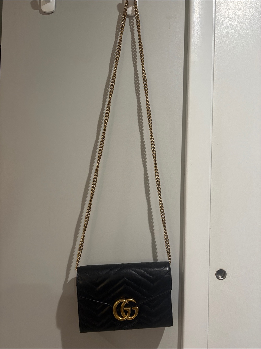 Black Quilted Leather Crossbody Bag with Gold Chain and Logo